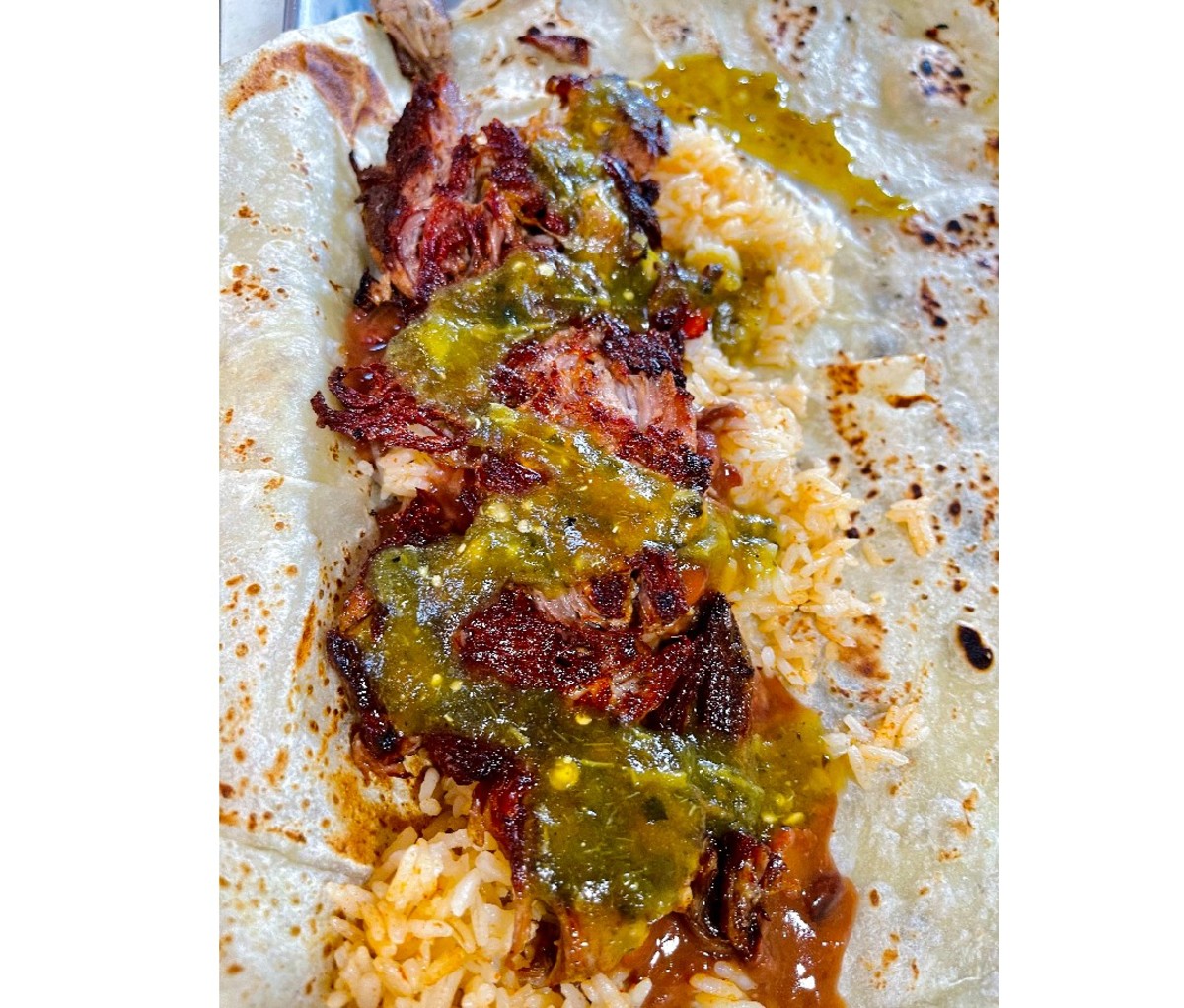 Open burrito ingredients on a tortilla from Portland's Saint Burrito