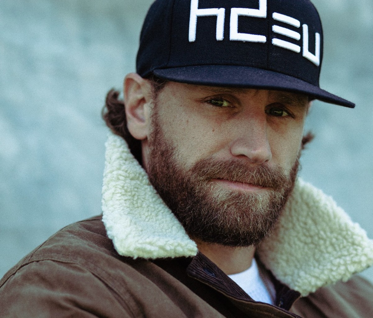 Close up of Nashville musician Chase Rice in a black ball cap.