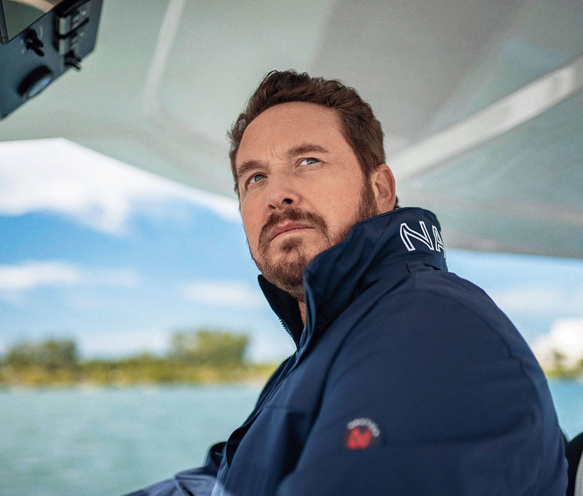 Caucasian man in navy blue Nautica windbreaker