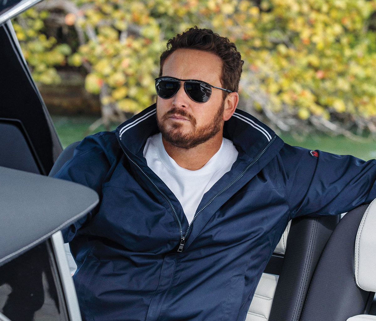 Caucasian man in navy blue Nautica windbreaker and black sunglasses