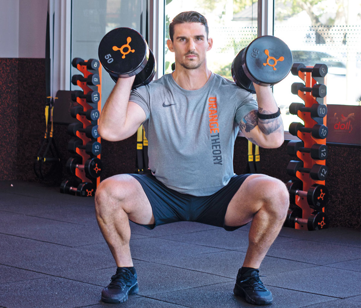 Dumbbell squats to alternating one-arm presses with rotation