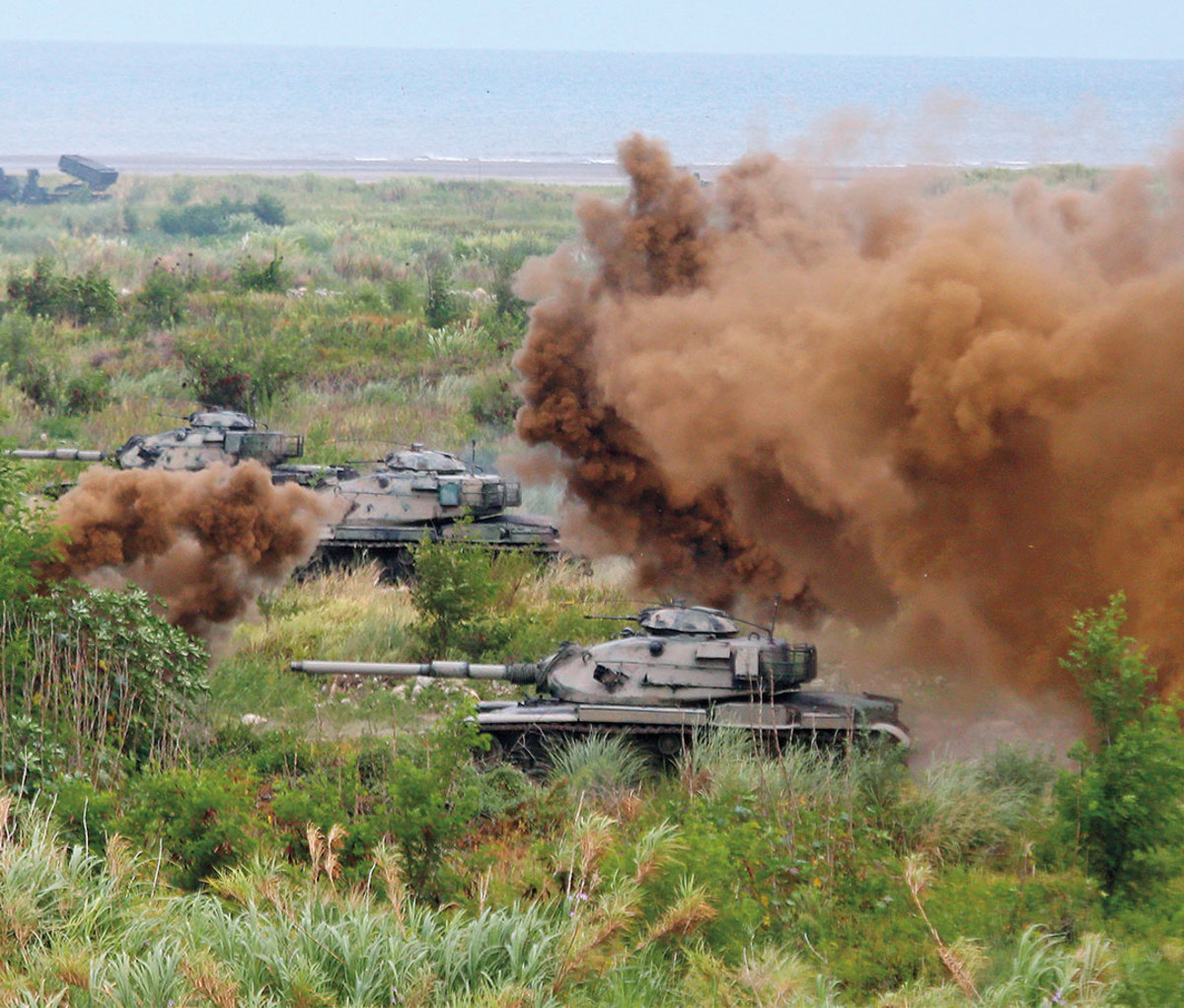 Tanks with dirt cloud from explosion