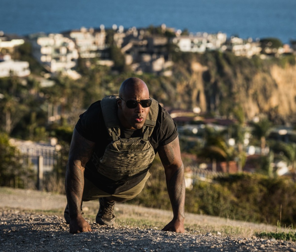Man doing pushup wearing weighted vest outdoors
