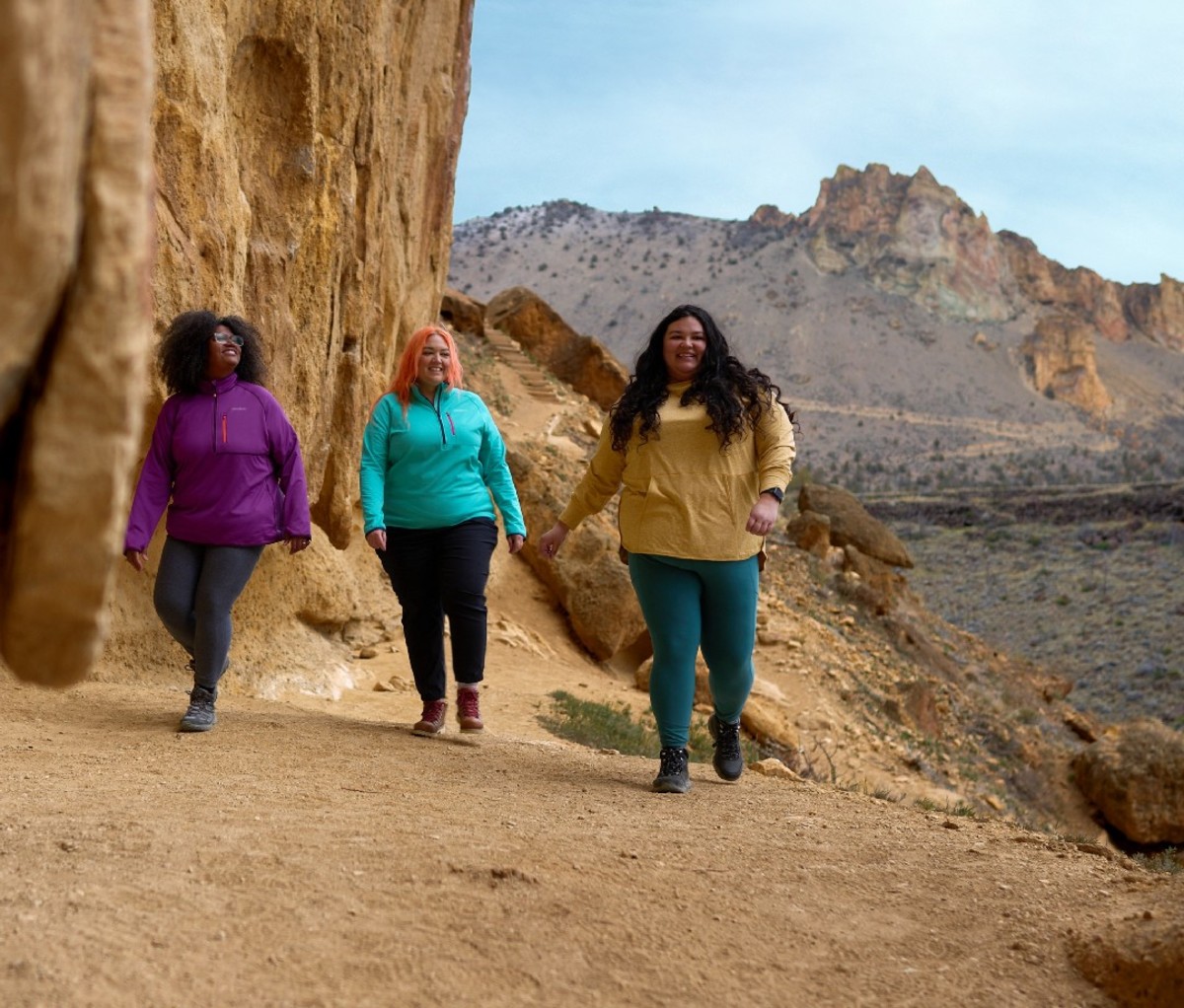 Three women hiking along a canyon trail