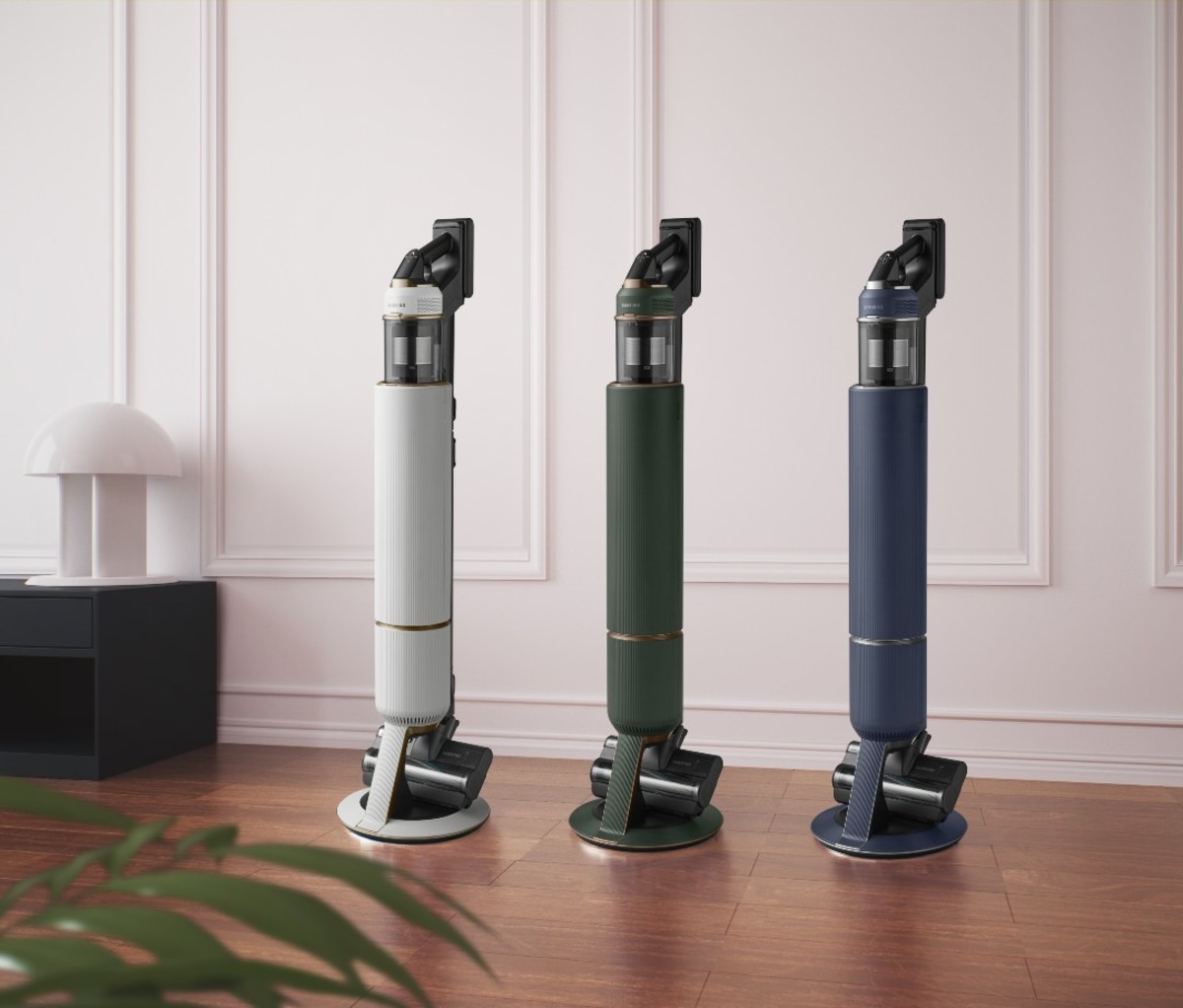 White, forest green, and navy blue vacuums