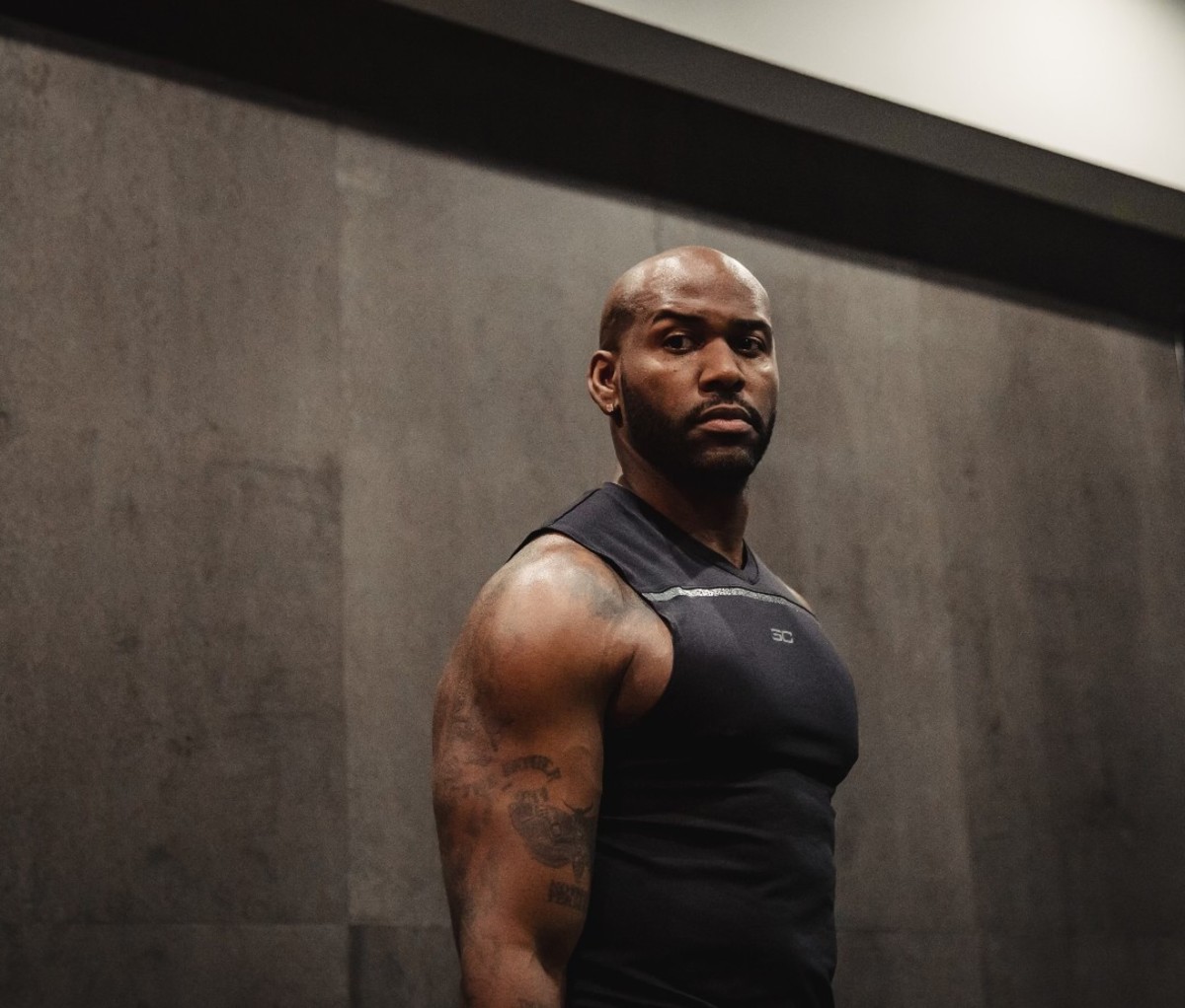 Black male with muscular physique wearing black tank top