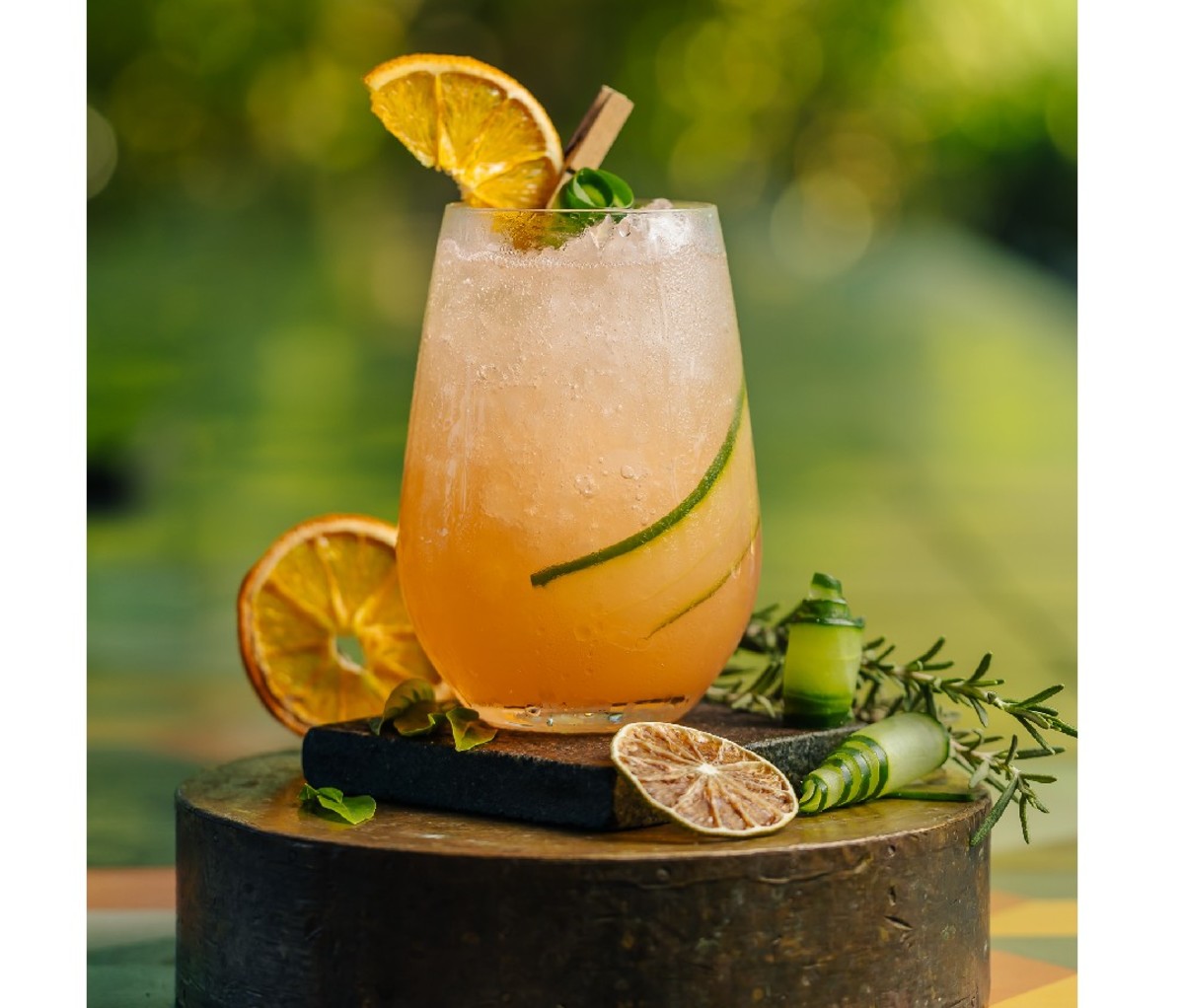 The California Sunset cocktail on an outdoor surface with garnish