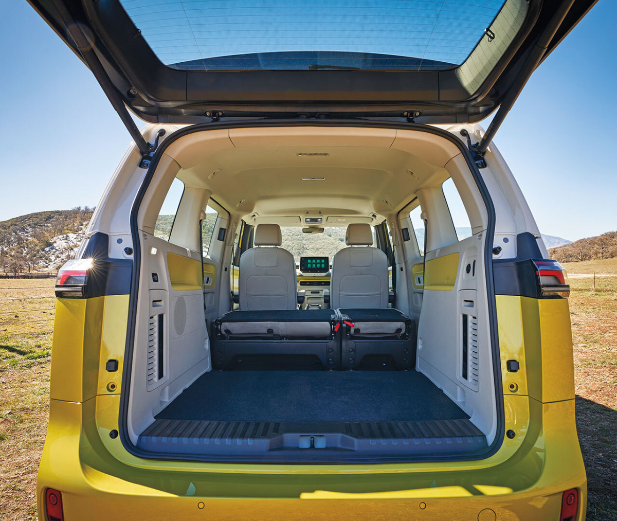 Interior from trunk of yellow and white Volkswagen ID.Buzz