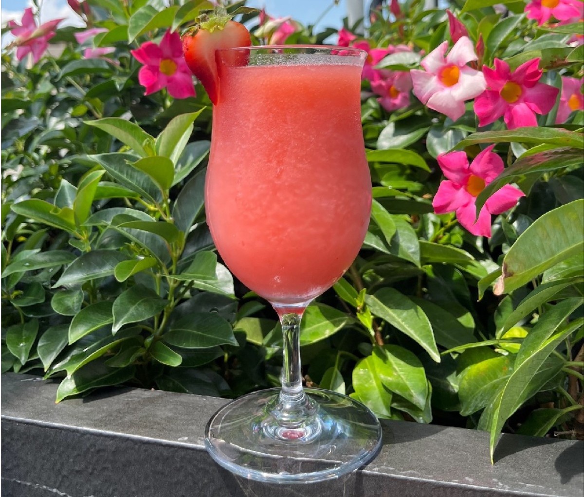 Frosé cocktail on a ledge with floral background