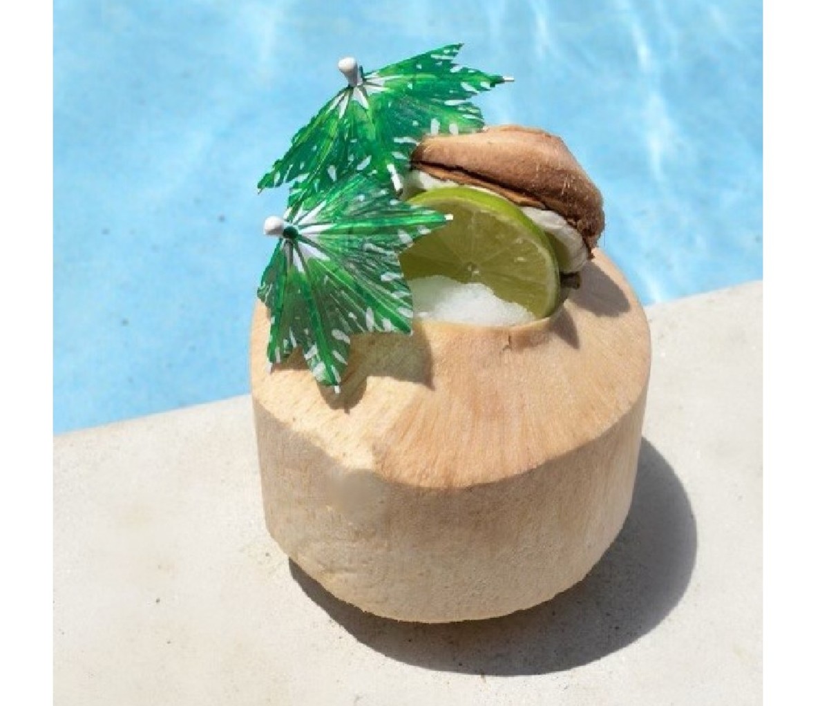 Kokomo Colada sitting poolside, served in a coconut