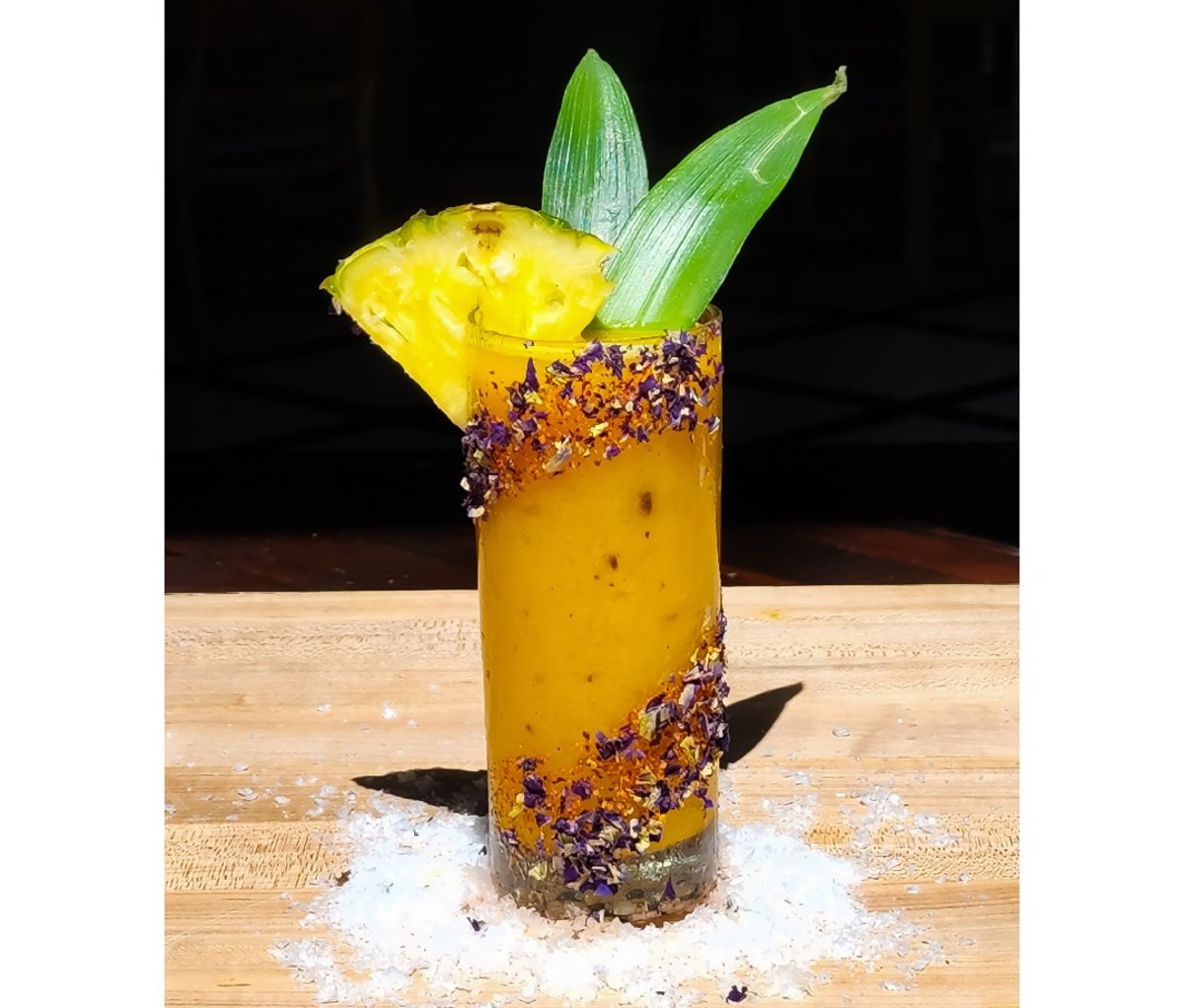 Smokin' Mangonada cocktail on a wooden surface.