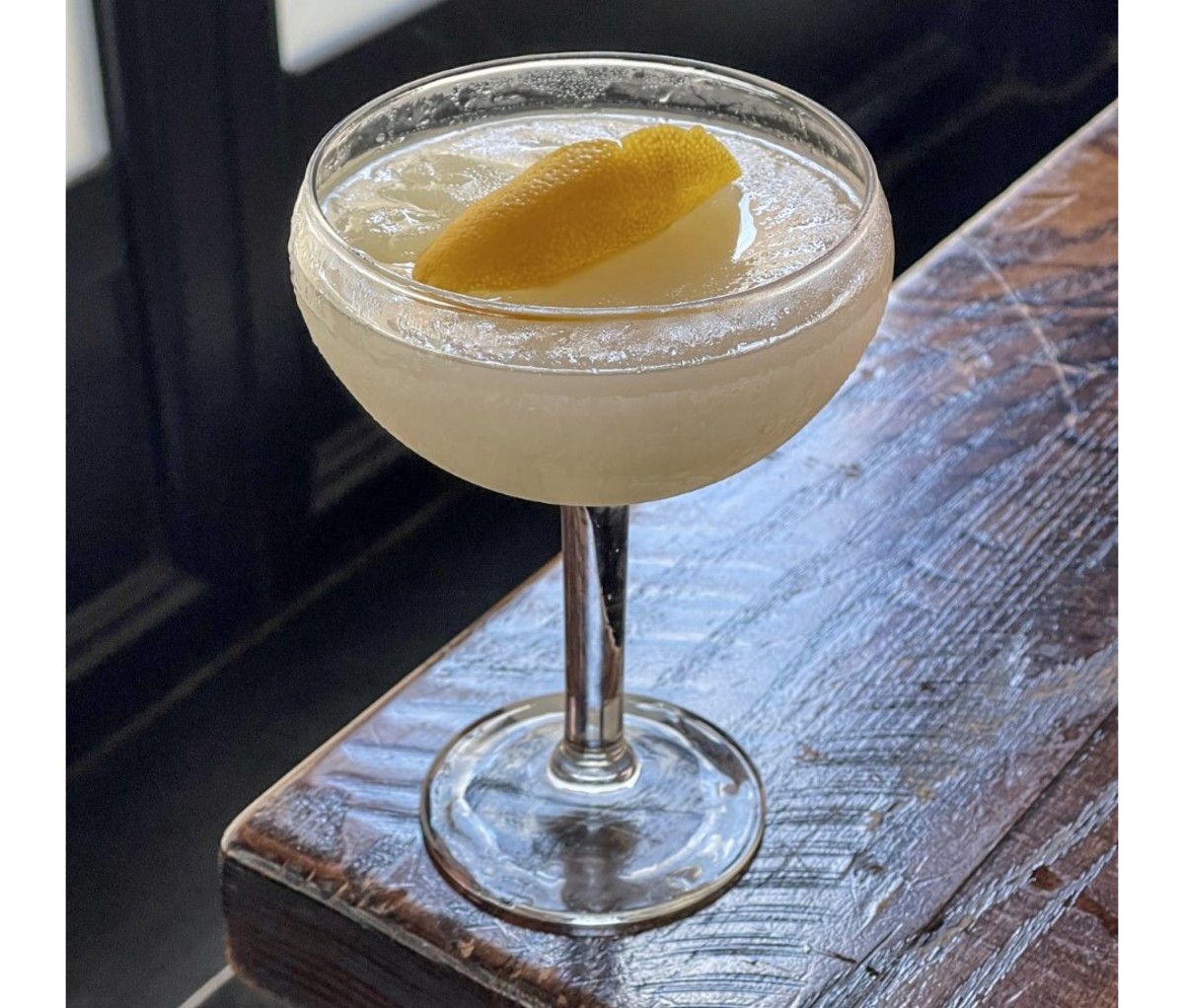 French 75 Slushie served in a coupe glass on a wooden counter