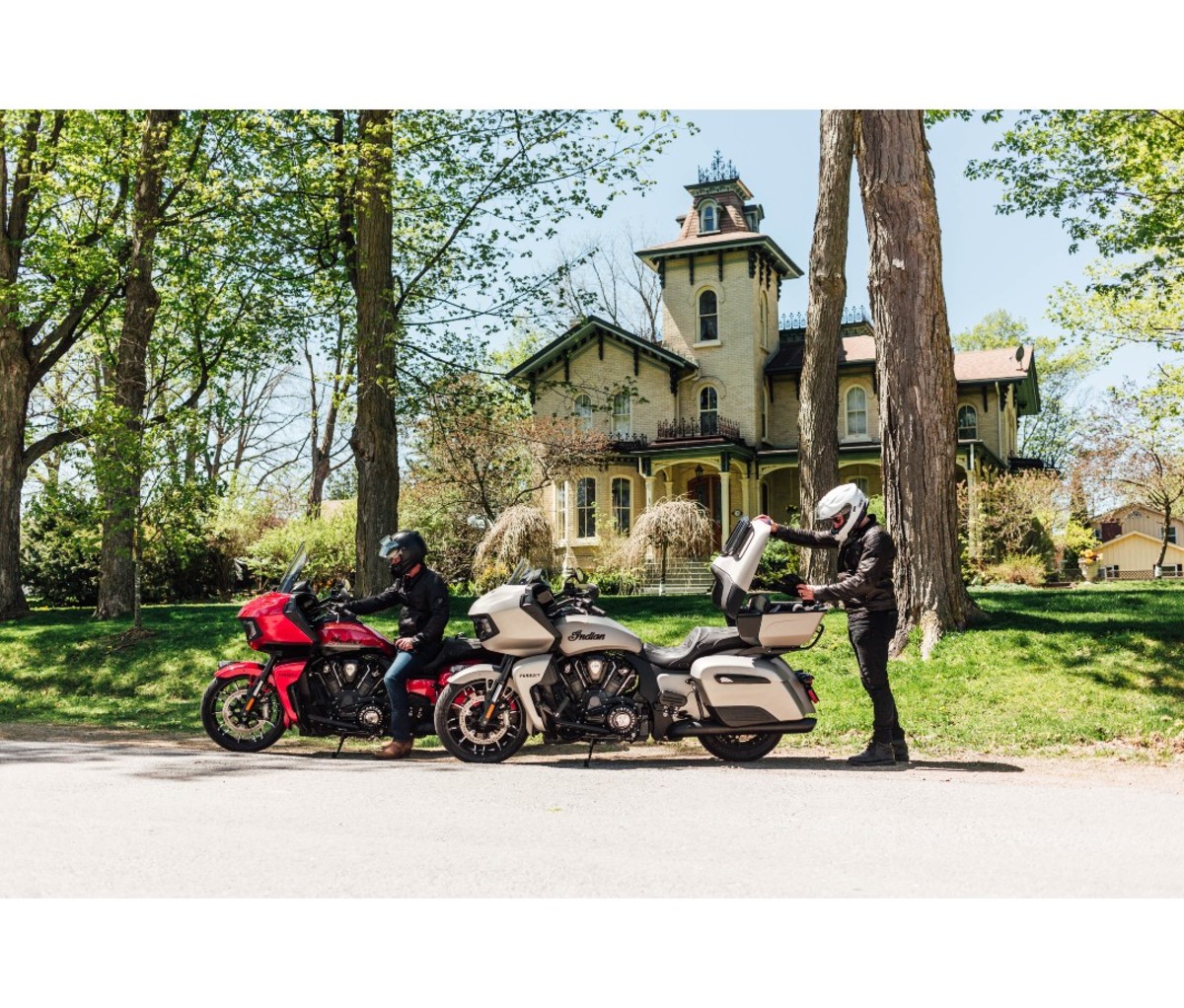 Two men on Indian Pursuit Dark Horse motorcycles in front of the ‘Bigelow House’ in Port Perry, Ontario. 