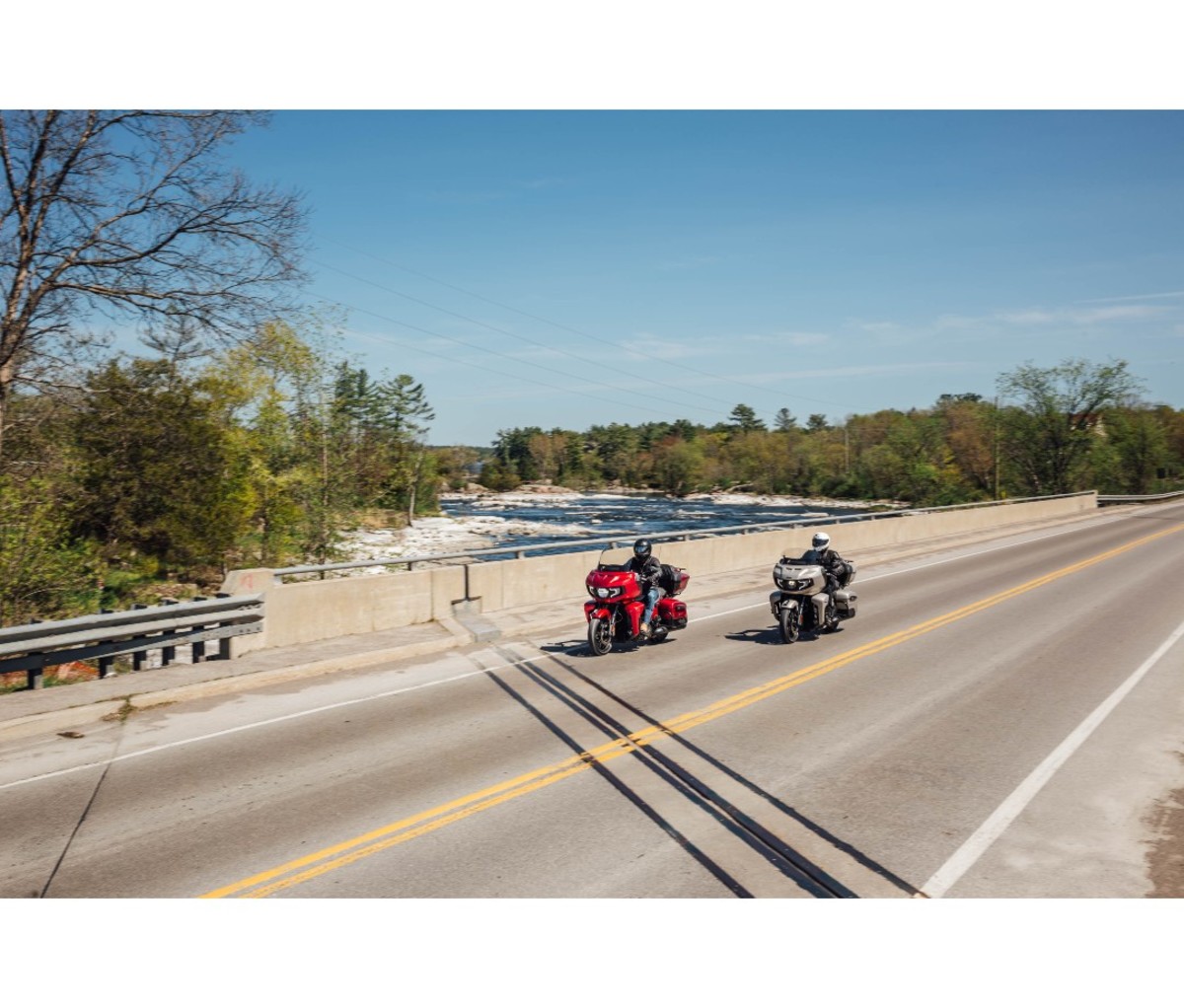 Two men riding Indian Pursuit Dark Horse motorcycles