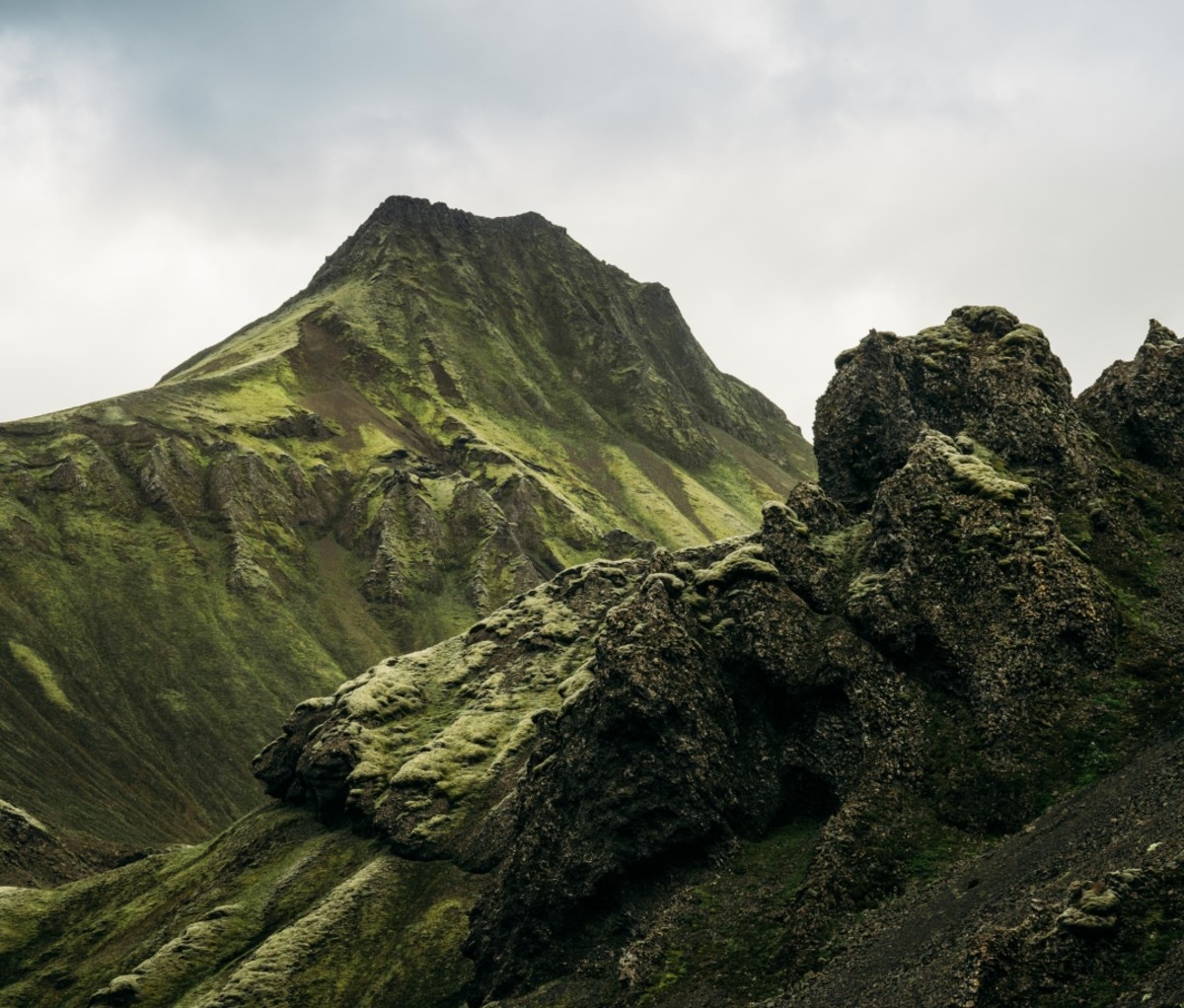 View of a green mountain cliff in Iceland. 57hours