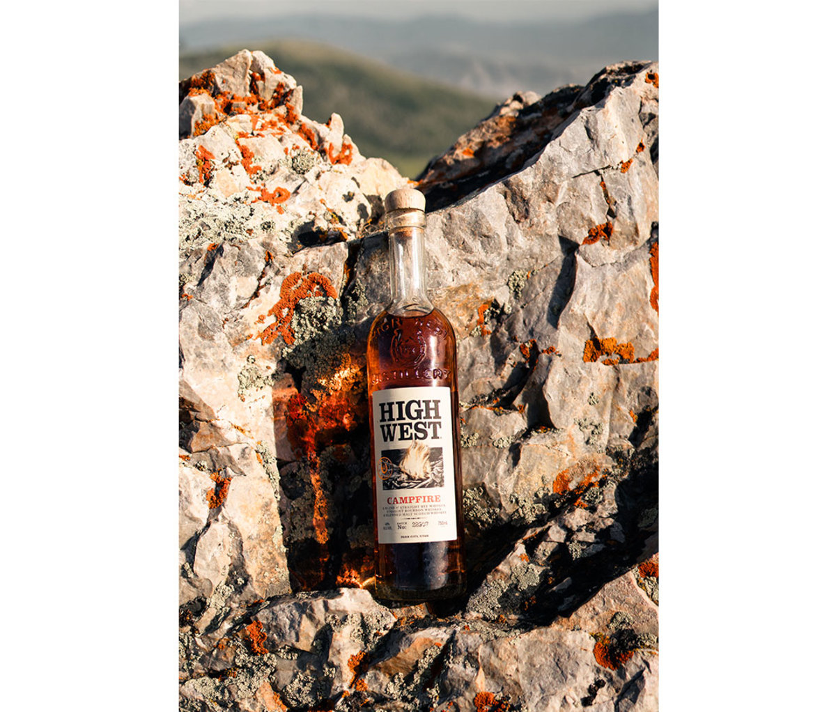 Bottle of High West Campfire whiskey sitting against rocks