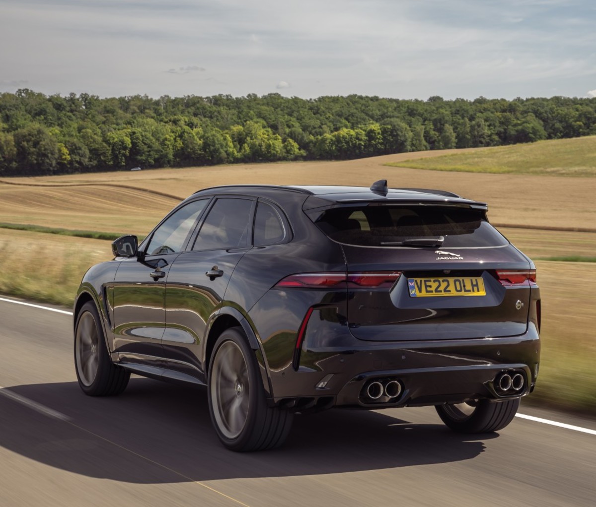 Dark purple luxury SUV driving along vineyards