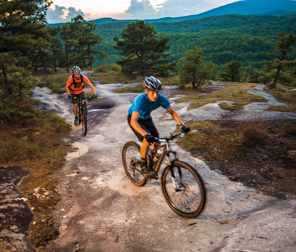 Mountain bikers going over smooth rock