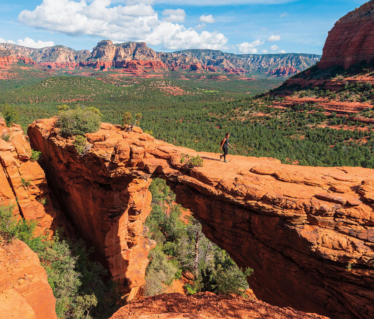 Walking across red rock formation in Arizona