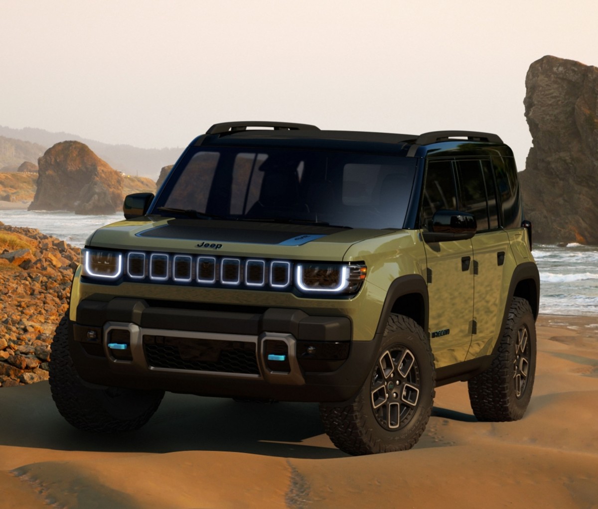 Jeep Recon parked on a beach viewed from the front.