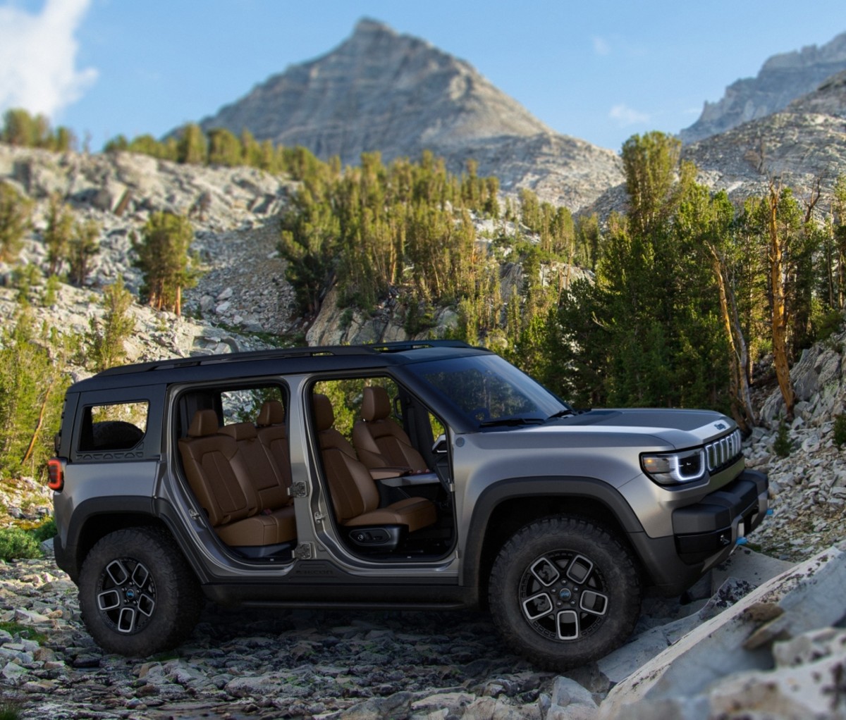 Jeep Recon parked on a rocky slope with its doors removed.