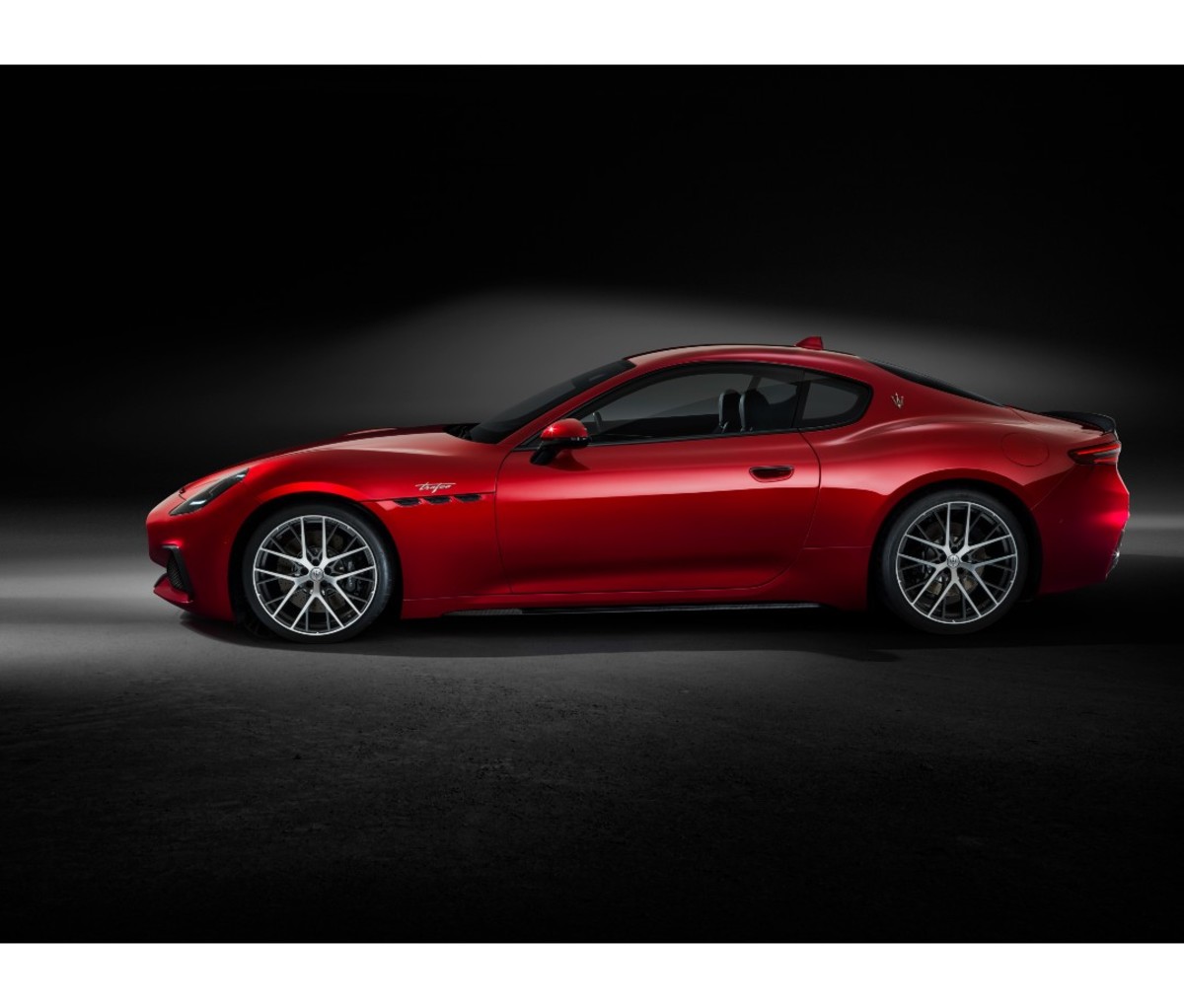 Red sports car coupe in black showroom