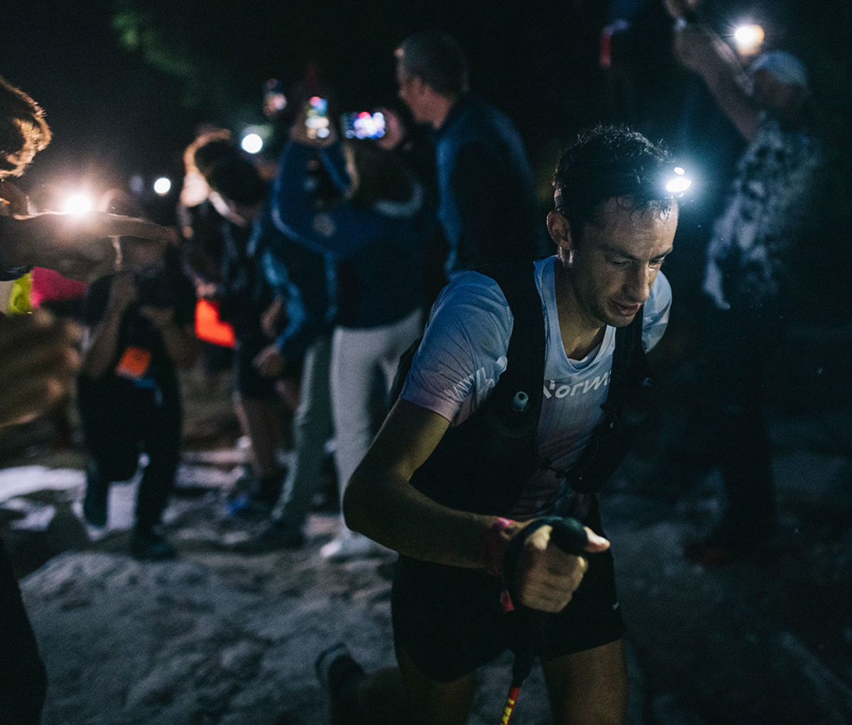 Ultrarunners climbing vertical with headlamps