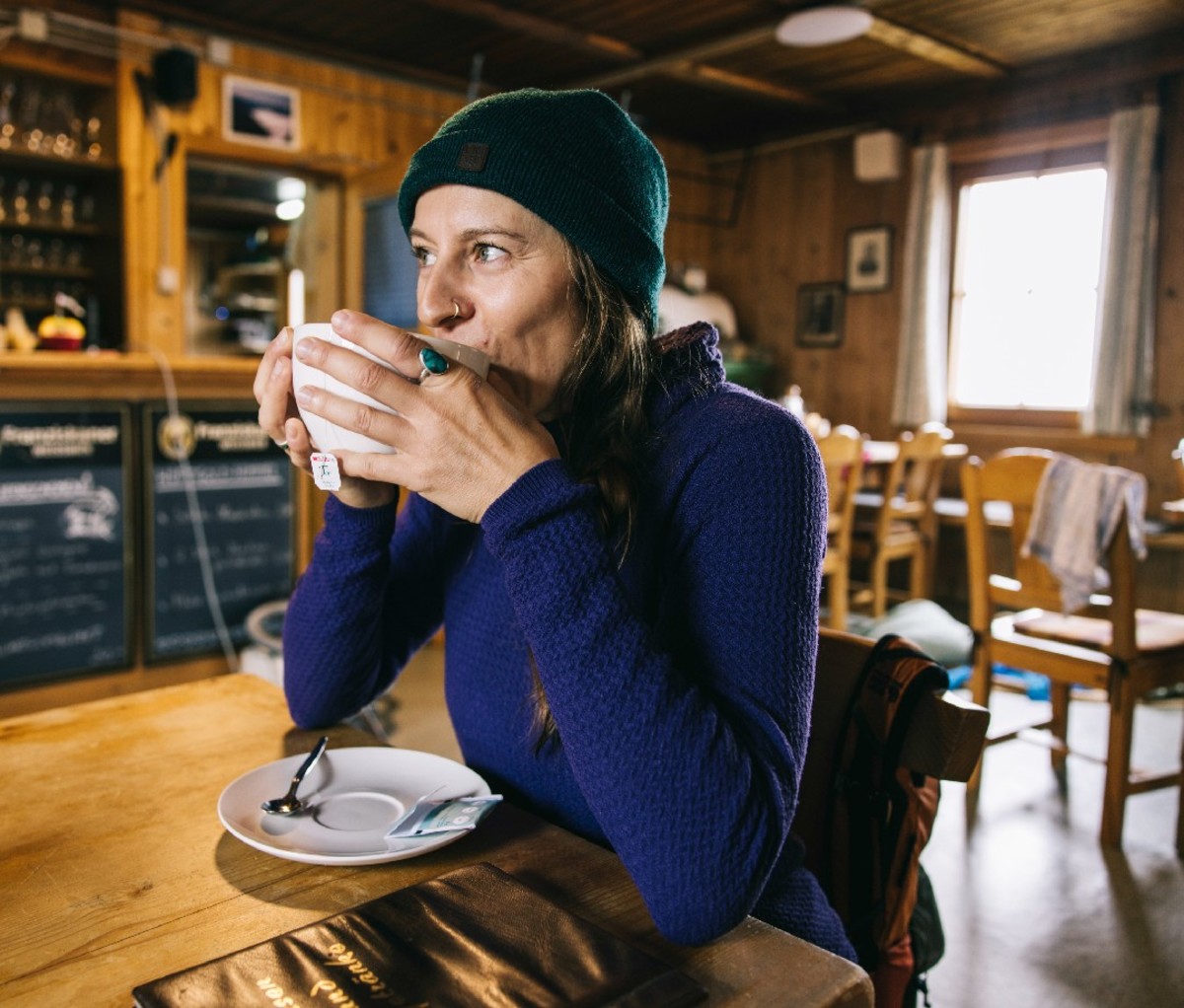 Hiker sipping coffee at a rest stop along Austria's Eagle Way