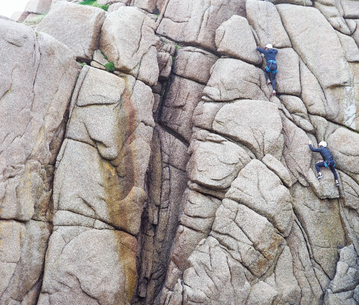 Climbers on a rock wall in Ireland