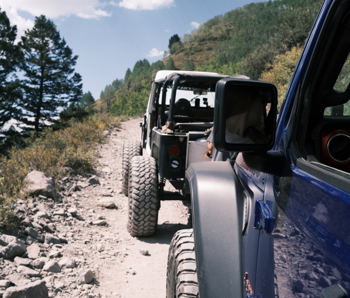 Driving all-wheel-drive vehicle on rocky dirt path