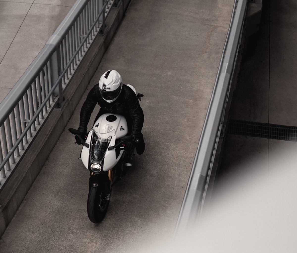 Person riding a Triumph Speed Triple 1200 RR.