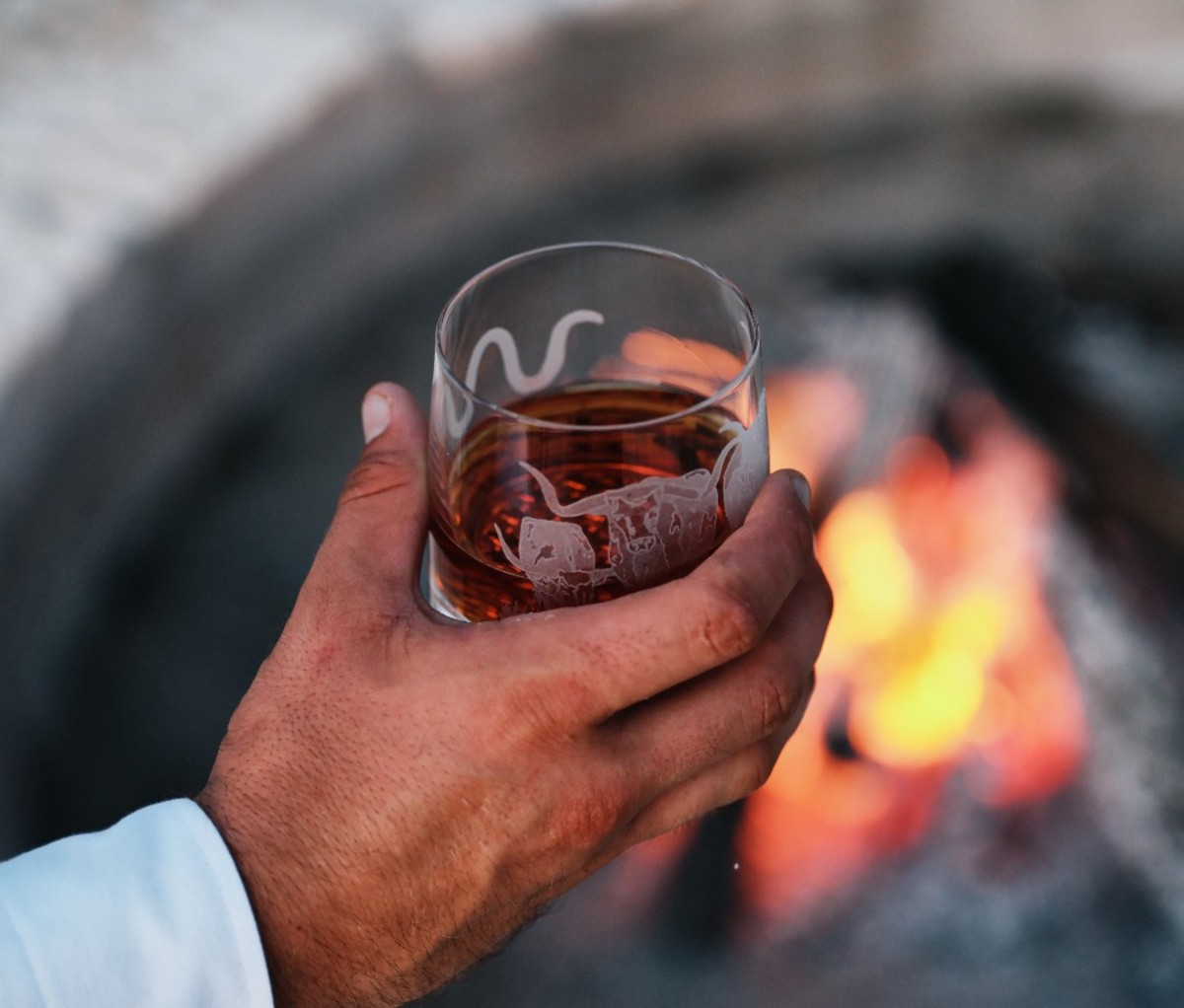 Dram of whiskey over campfire