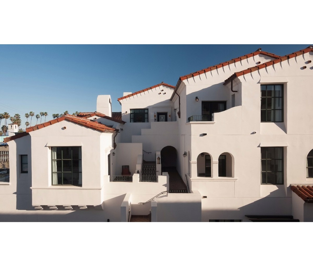 Exterior of Spanish Colonial style building with terracotta tile roof and white stucco walls