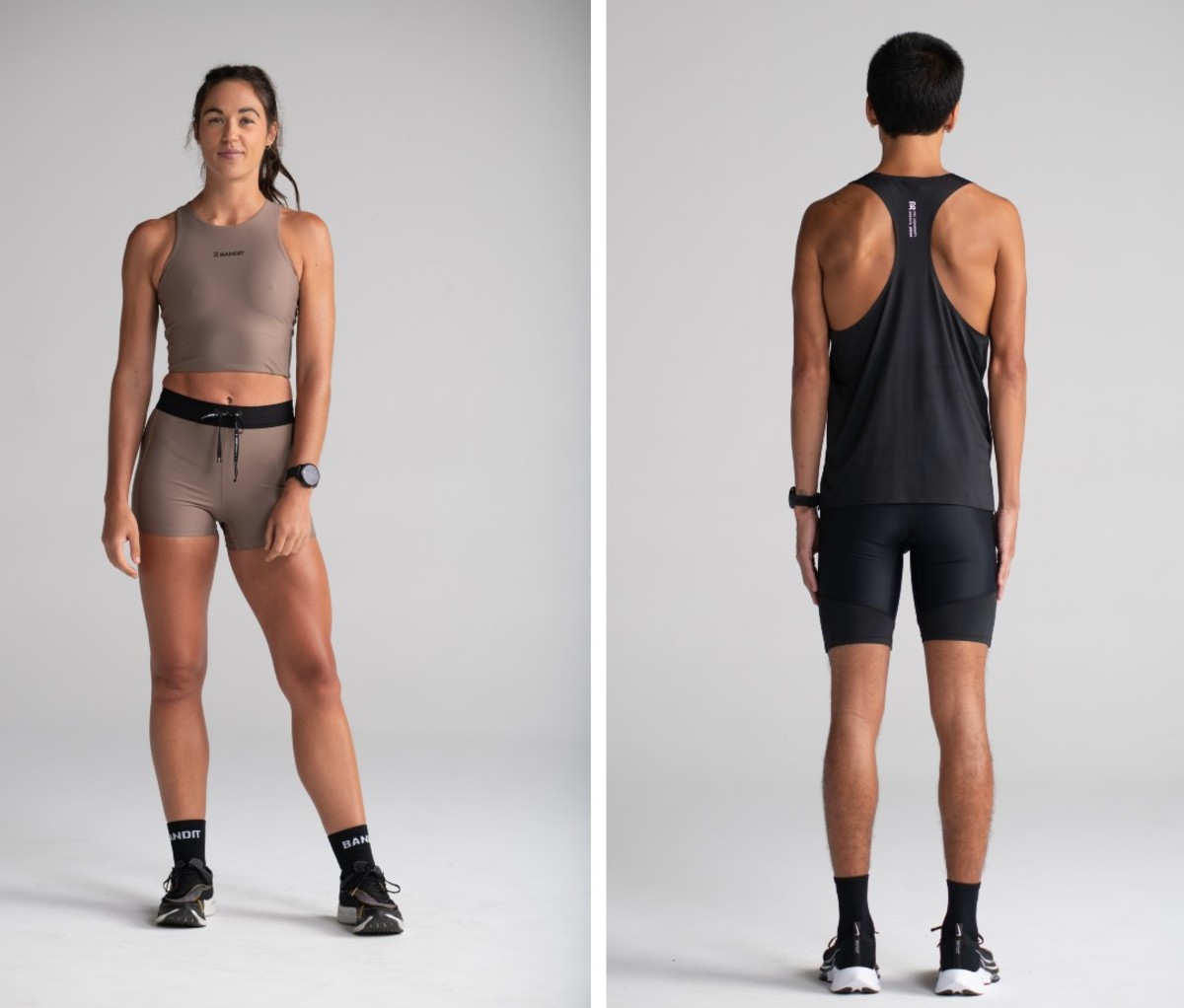 Male and female models posing against grey backdrop in black and taupe running kits