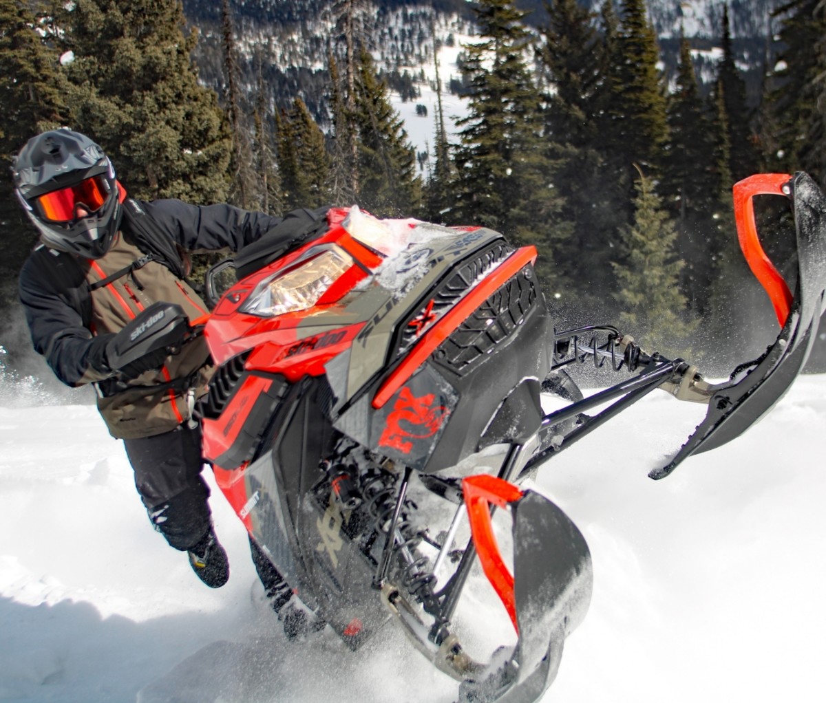 Man riding a ride snowmobile.