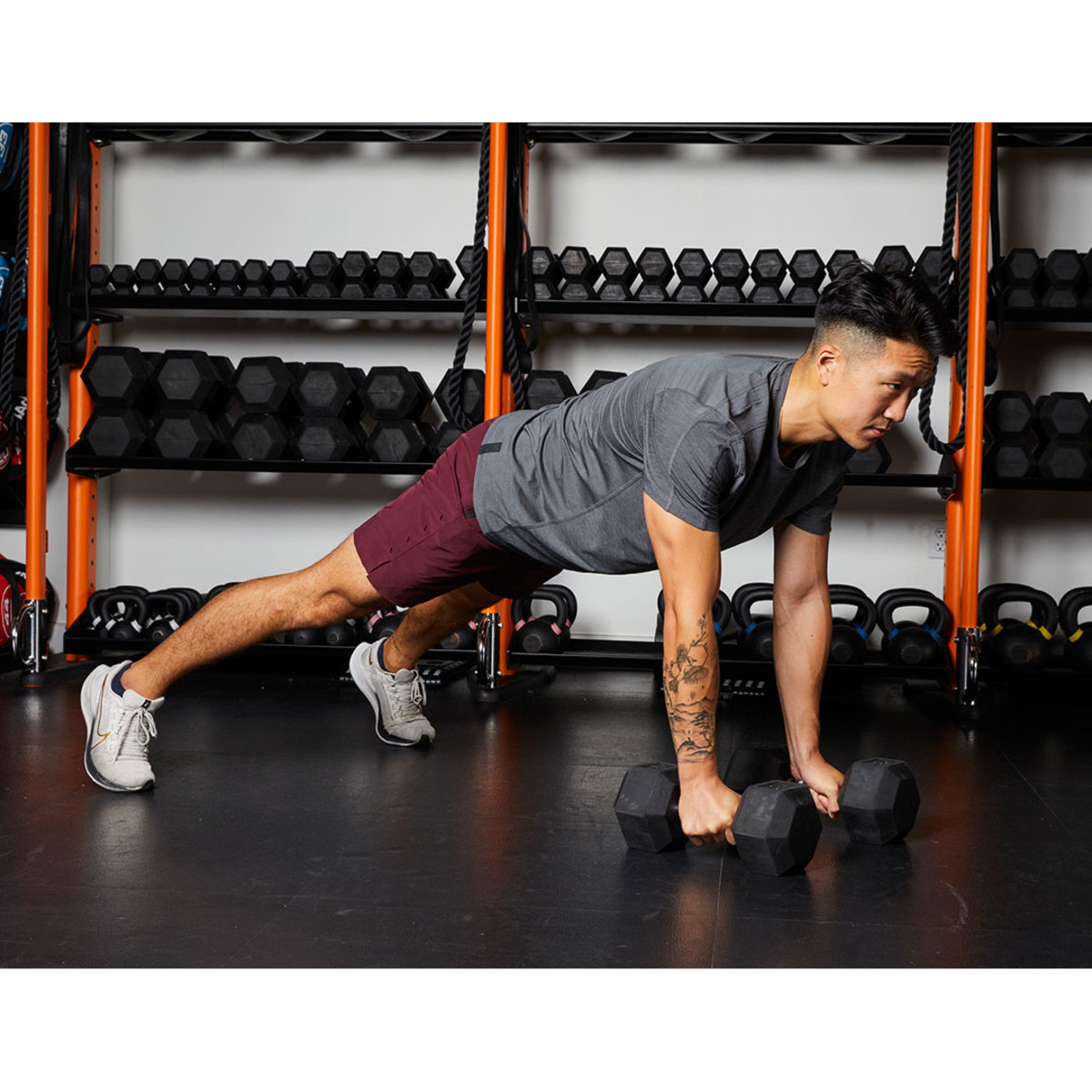 Athletic man wearing gray T-shirt and maroon shorts renegade row