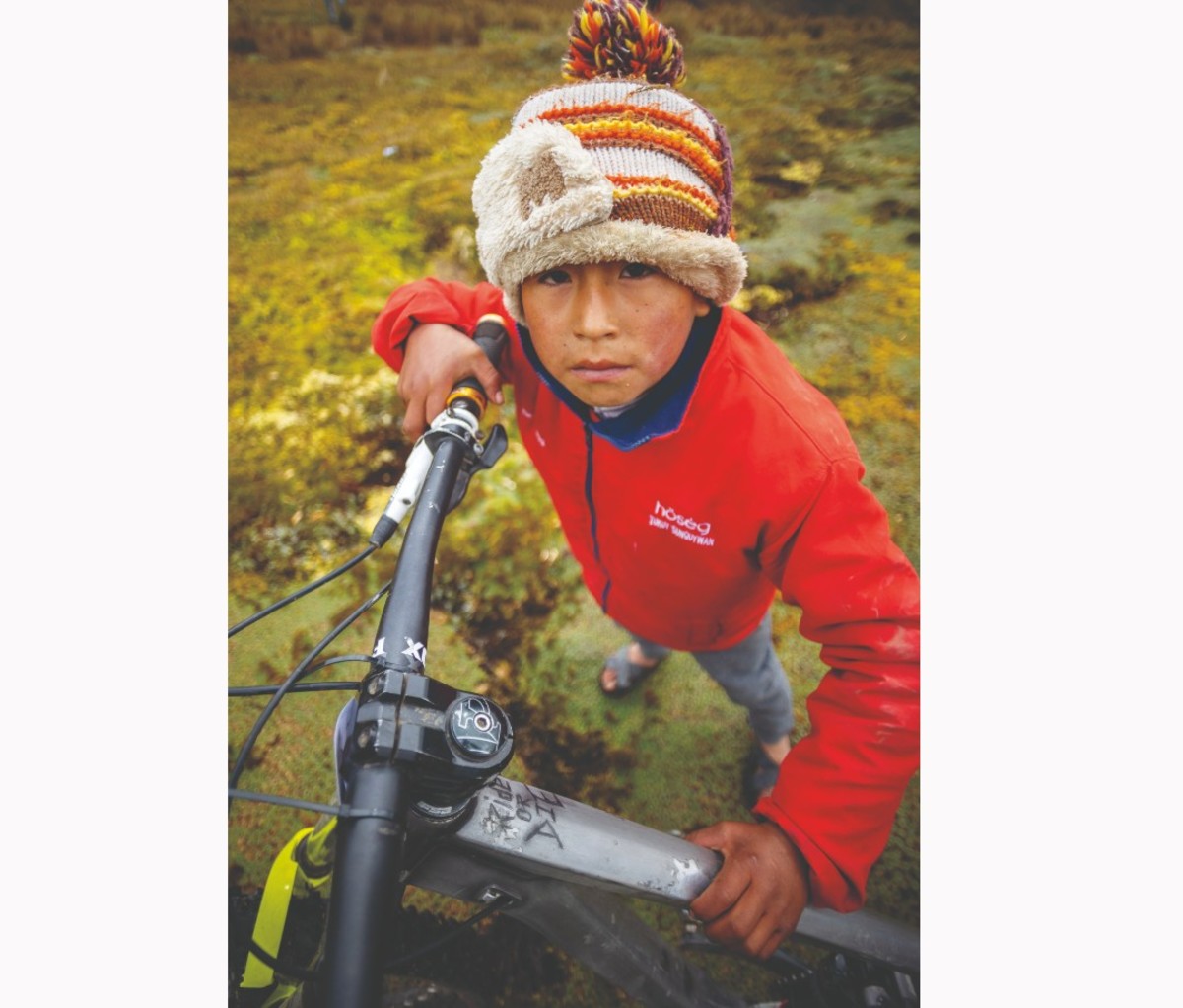 Small Peruvian child in red sweater and knit hat