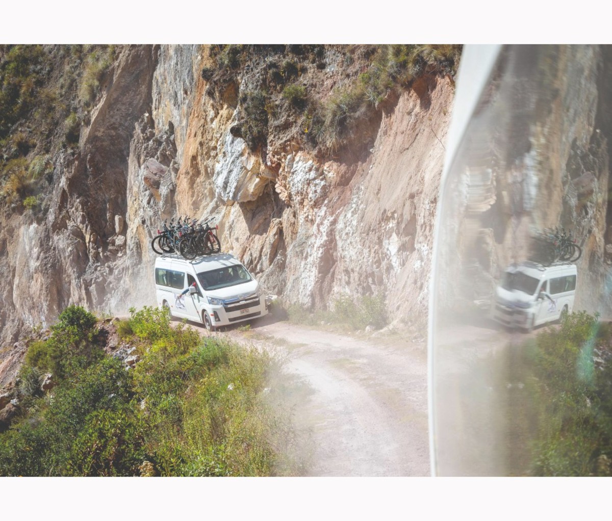 Car with mountain bikes going up mountain