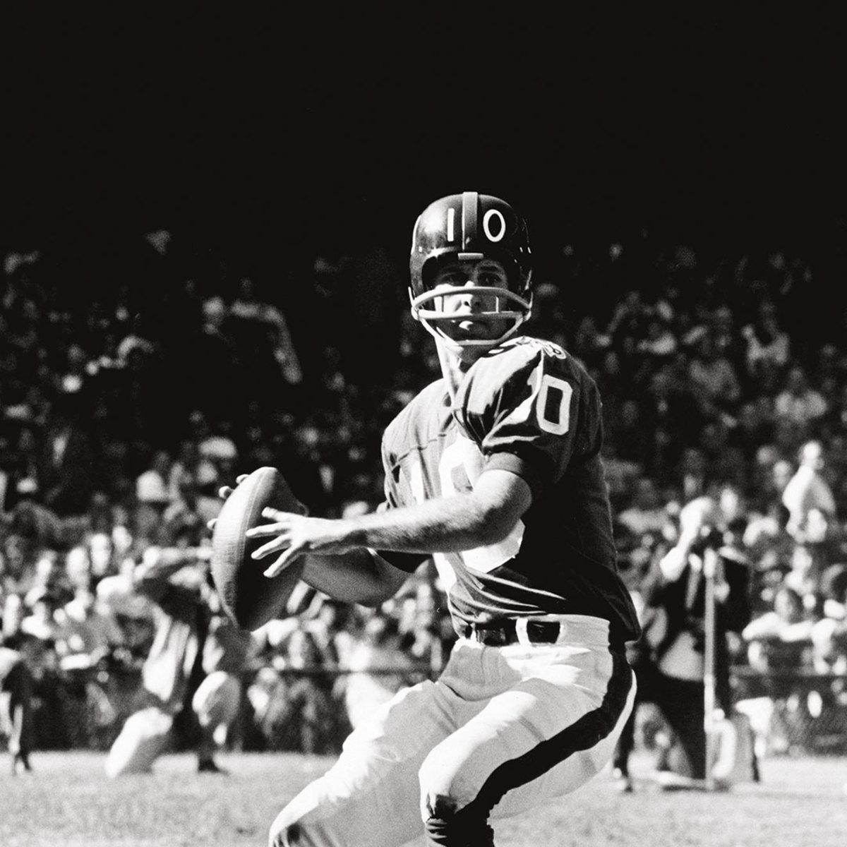 Black and white photo of football player about to throw ball