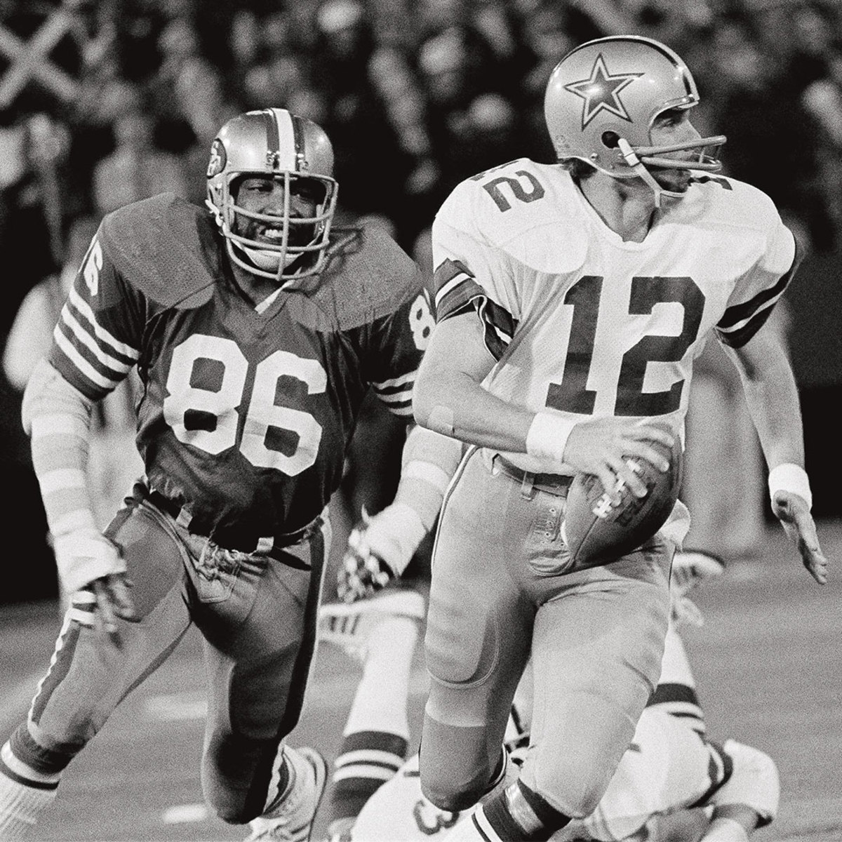 Black and white photo of football quarterback about to be sacked