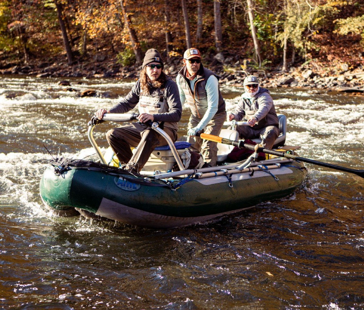 Three men rafting down some light rapids in North Carolina.