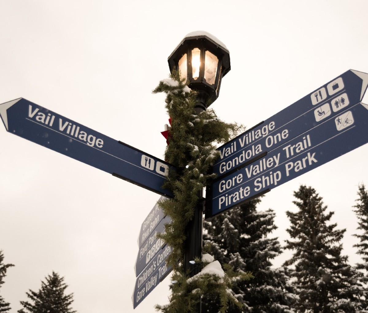 Vail Village lamp post with signs to attractions.