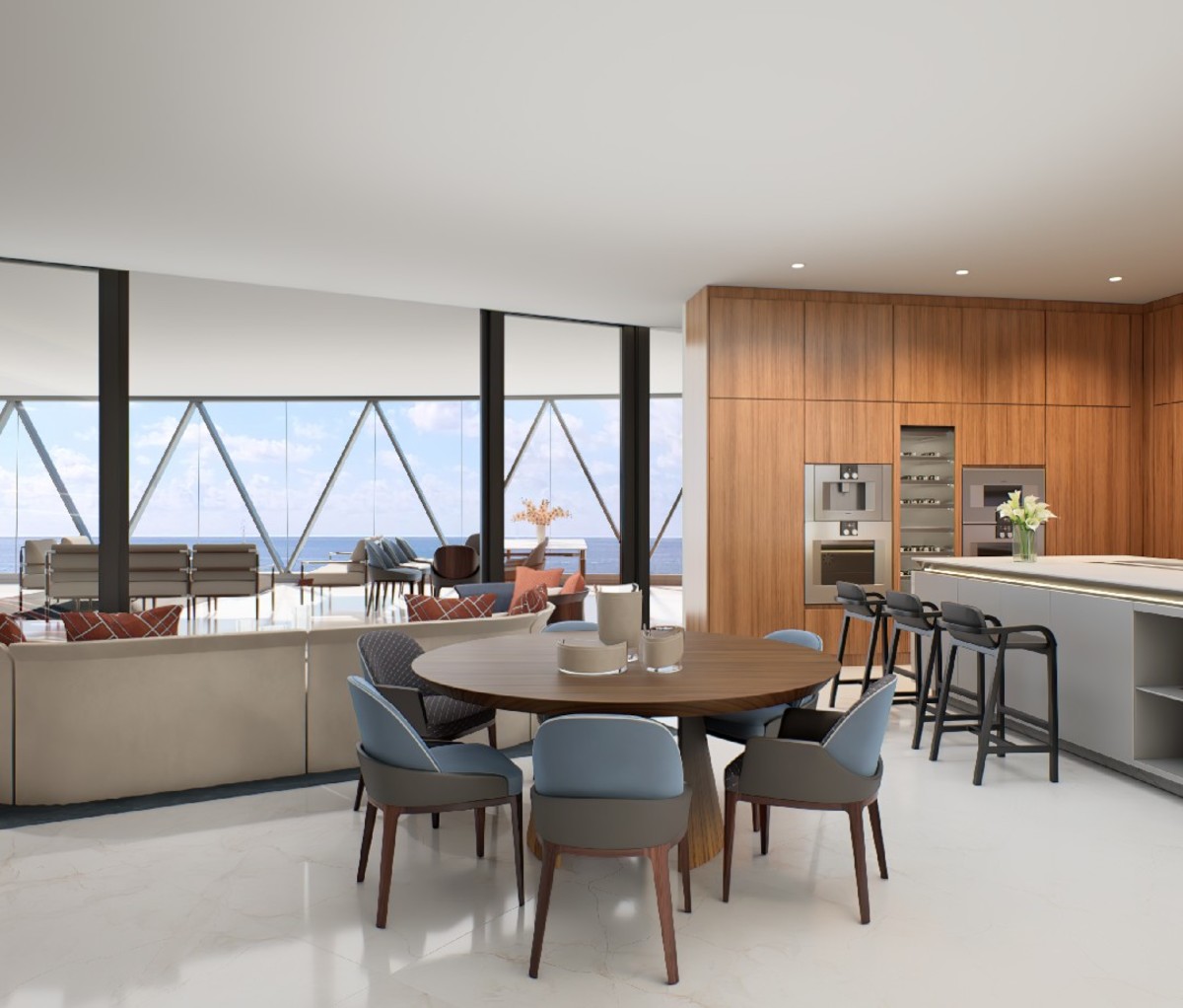 Dining and kitchen area of Bentley Residences Miami, with ocean view in background.