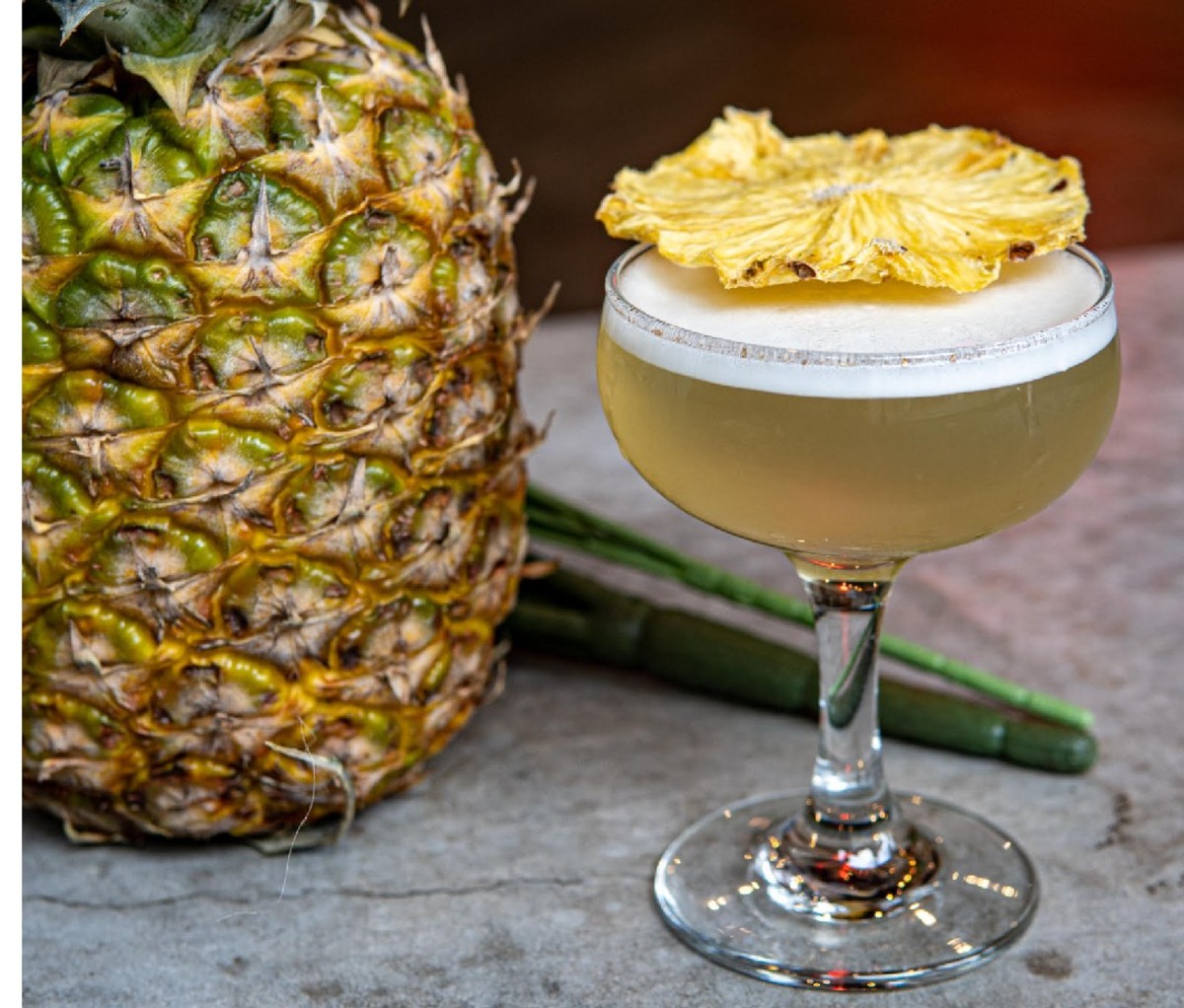 Cocktail with pineapple garnish at Two Arrows.