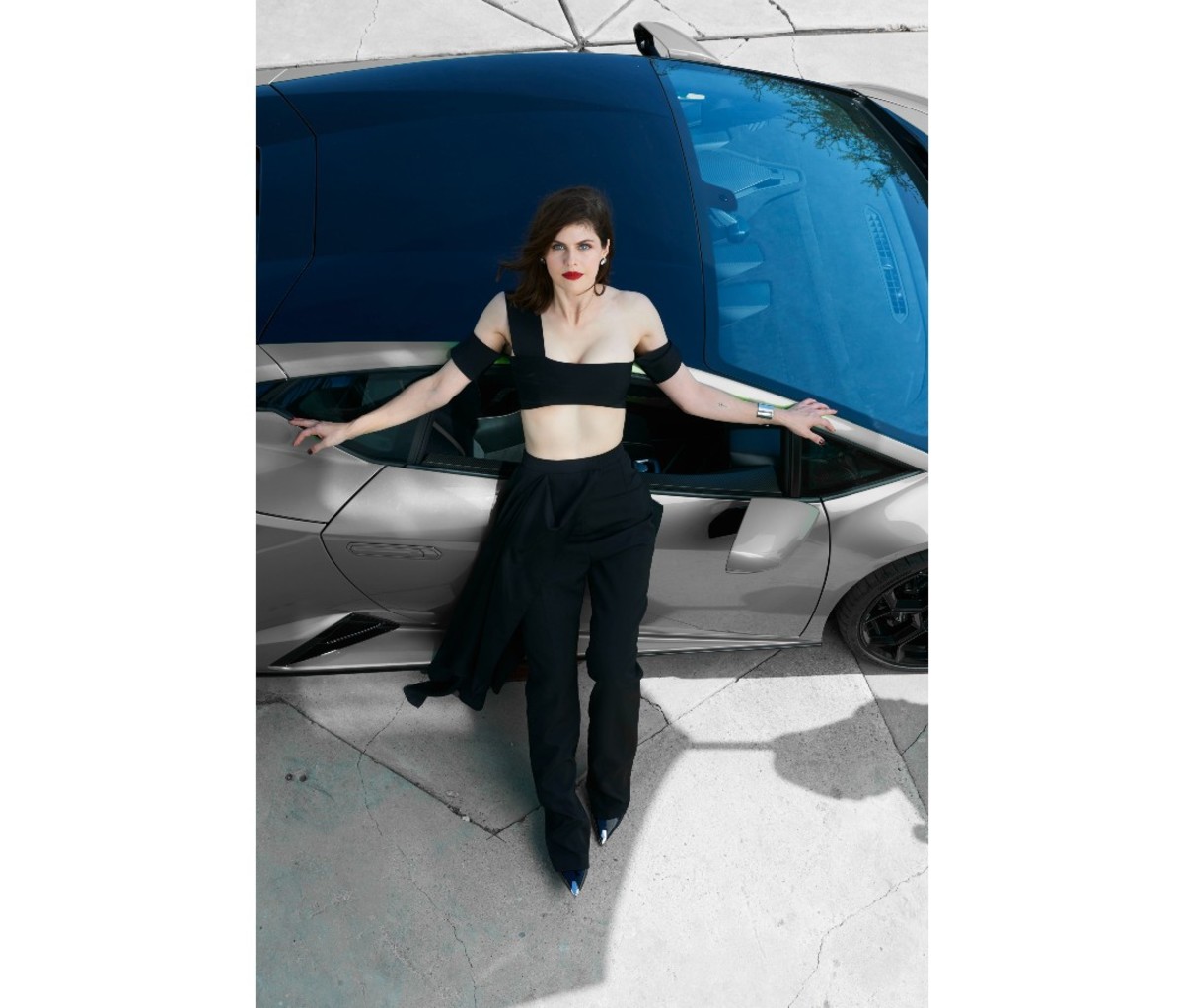 Alexandra Daddario posing by a car