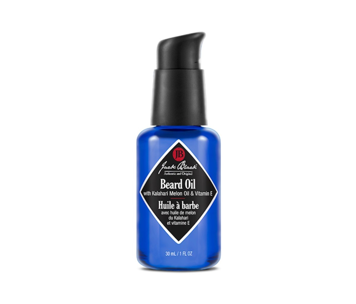 Blue bottle of beard oil with a black diamond-shaped label.
