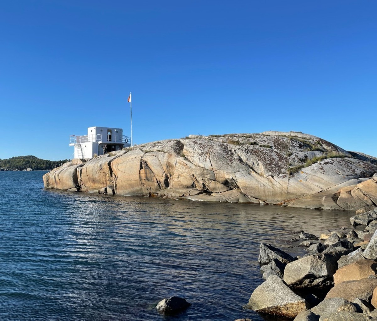 Whaleship wheelhouse on rocky island