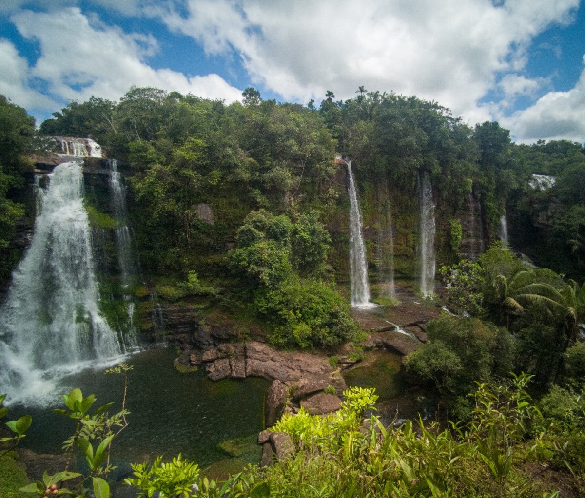 Series of waterfalls spill over a rain forest cliff in Colombia's Meta district.