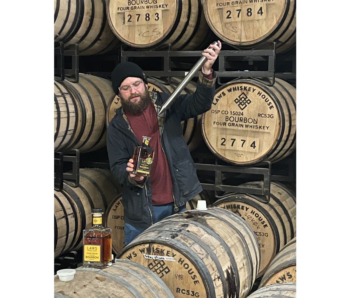 Author Brad Japhe sampling whiskey from Laws distillery.