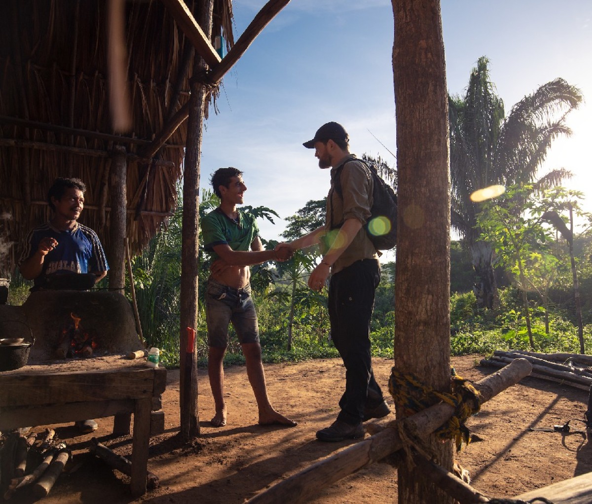 Traveler in Colombia shakes hands with locals in in a rural area.